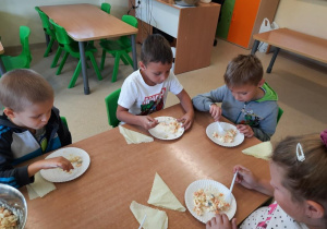 Dzieci jedzą zdrową sałatkę warzywną